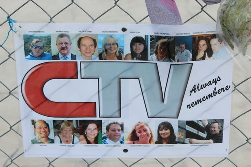 A photograph of a laminated poster of images of CTV staff who died on 22 February 2011. In the middle of the page is the CTV logo, accompanied by the words "Always remember".