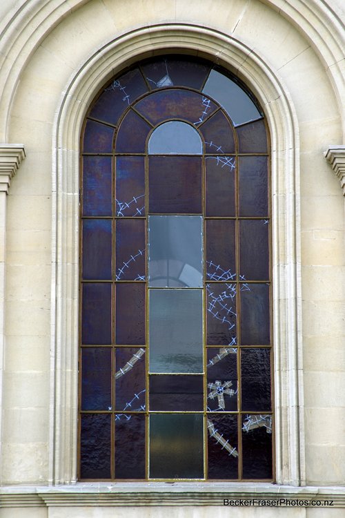 Basilica, damaged stained glass window, taped up